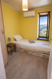 a small room with a bed and a window at Vista Mare in Afissos