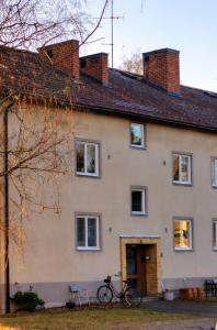 a house with a bike parked in front of it at You Can Sleep Here in Hävla Bruk