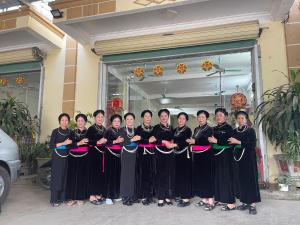 a group of women holding a ribbon in front of a building at Hotel Thi Hoa Bai Dinh in Ninh Binh