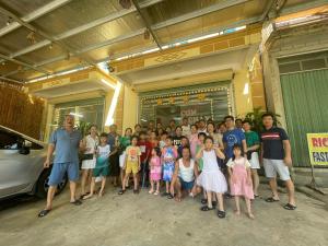 a group of children posing for a picture in front of a building at Hotel Thi Hoa Bai Dinh in Ninh Binh