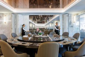 a meeting room with a large round table with chairs at Maritztel Bangkok Hotel in Ban Bang Toei (1) +102 photos