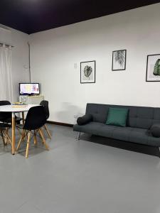 a living room with a couch and a table at EzeApart in Ezeiza
