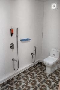 a bathroom with a toilet and two showers at Sea Shades Palolem Resort in Palolem +12 photos