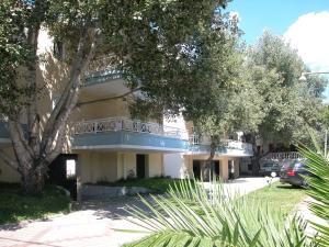 a building with a balcony on the side of it at Hotel Nestor in Toroni