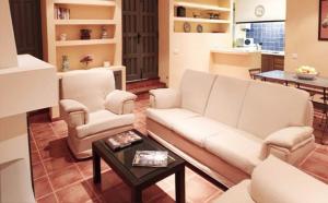 a living room with a white couch and a table at Casas Rurales La Lapa in El Cerro del Hierro