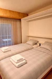 Кровать или кровати в номере Studio SUD - Résidences des Bains d'Ovronnaz - Alpstay S204