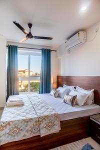 a bedroom with a large bed with a window at Borail Homes in Silchar