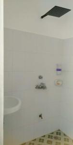 een witte badkamer met een wastafel en een douche bij Solaya Cove Private Resort in Bansud +30 foto's