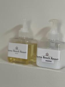 twoented candles sitting on a shelf in a bathroom at Sama Beach Resort by Munchies Resort in Ban Tai