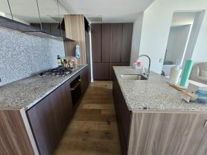 a kitchen with a sink and a counter top at Sunset Sky Nest CBD 65F in Melbourne +9 photos
