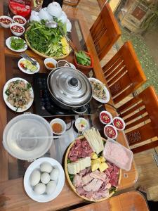 a table with many plates of food on it at Hotel Thi Hoa Bai Dinh in Ninh Binh