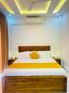 a bedroom with a large bed with two lamps at Sky View in Matara