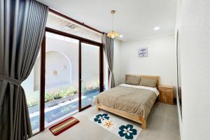 a bedroom with a bed and a large window at The Sky Homestay in Ấp Khánh Phước (1)