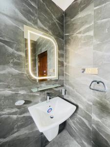 a bathroom with a white sink and a mirror at Sky View in Matara