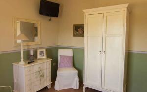 a room with a white cabinet and a chair at Agriturismo Poggio Alle Serre in Gallinaro