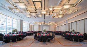 ein Bankettsaal mit Tischen und Stühlen in einem Raum mit Fenstern in der Unterkunft Mumian Rizhao Hotel in Rizhao + 222 Fotos