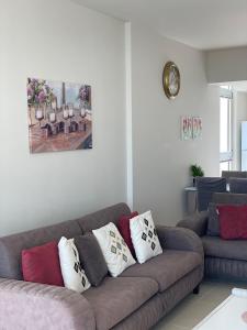 a living room with a couch with pillows on it at Sea Breeze Suites by the Coast in Iskele