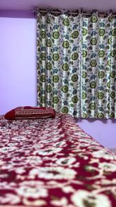 a bedroom with a bed with a curtain and a window at Awadh homestay in Varanasi +4 photos