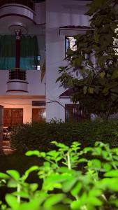 a building with a clock tower in the background at Awadh homestay in Varanasi