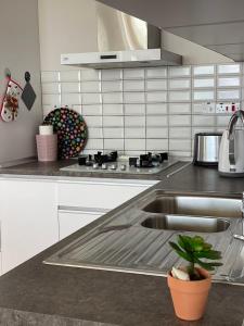 a kitchen with a sink and a counter top at Sea Breeze Suites by the Coast in Iskele +27 photos
