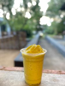 a drink in a cup sitting on a table at ใจกลม โฮมคาเฟ่ in Ban Hua Phrong