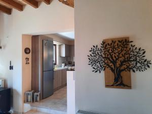 a kitchen with a tree stencil on the wall at Τα πέτρινα στο Σκεπαστό in Kalavrita +47 photos