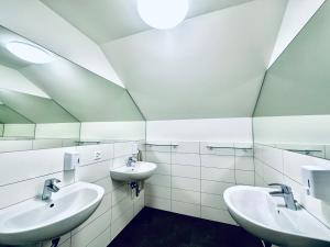 a bathroom with two sinks and two mirrors at Monteurzimmer - Worker's accommodation - ZIMMERzuVERMIETEN in Lengnau BE in Lengnau +16 photos
