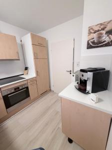 a kitchen with a counter with a microwave and a stove at FerienwohnungNord in Singen