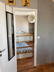 a bedroom with two bunk beds and a mirror at Appartement centre in Quiberon +2 photos
