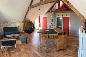 a kitchen and living room with a table and chairs at Appartement centre in Quiberon