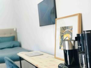 a coffee maker on a table next to a couch at Private apartment with hotel feeling in Hudiksvall