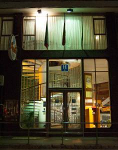 a store front with windows at night at Hotel La Ronda in Castro-Urdiales