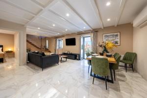 a living room with a table and chairs and a couch at Casa Sorgente in Ágioi Doúloi