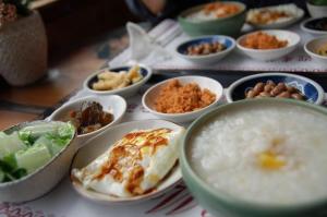 a table topped with bowls of food on a table at E-Home Kulai in Kulai