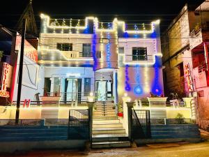 a white building with lights on the front of it at GOKUL Hotel in Maheshwar