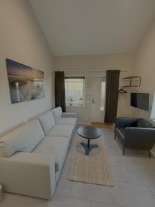 a living room with a couch and a table at Stugcentralen Lägenhetshotell & Stugor in Halmstad