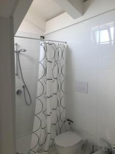 a white bathroom with a toilet and a shower at Casa Maria in Salerno
