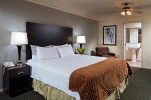 a hotel room with a large bed and a bathroom at The Willows Hotel in Chicago