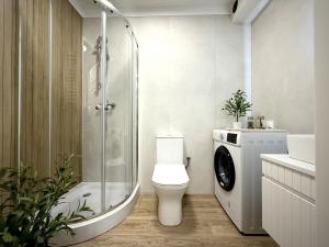 a bathroom with a toilet and a glass shower at Willa na Dębowej in Katowice +59 photos