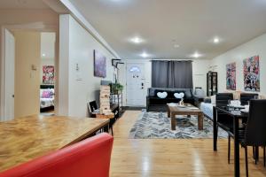 a living room with a table and a couch at FREE PARKING - In-Suite WASHER & DRYER - fully stocked KITCHEN - WORKSPACE PROVIDED - FAST WIFI - 5 minute walk to the most CENTRAL metro station IN MONTREAL - BERRI UQAM in Montréal