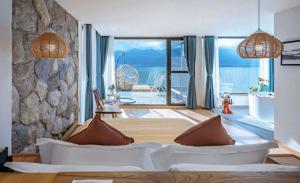 a bedroom with a couch and a stone wall at Nanshe Nan Inn Dali in Dali Airport