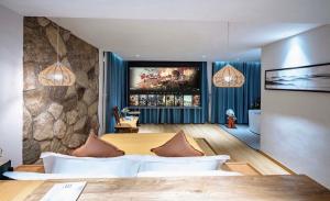 a bedroom with a bed and a tv on a wall at Nanshe Nan Inn Dali in Dali Airport