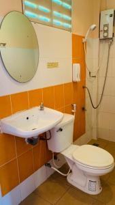a bathroom with a toilet and a sink and a mirror at Yada Resort Koh Yao Noi in Ko Yao Noi