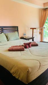 a bedroom with a large bed with pillows on it at Yada Resort Koh Yao Noi in Ko Yao Noi