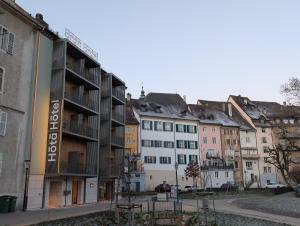 a row of buildings in a city at Hota Hotel Porrentruy in Porrentruy