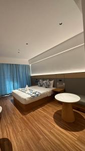 a bedroom with a large bed and a table at Bohol panglao Diver's home resort in Panglao