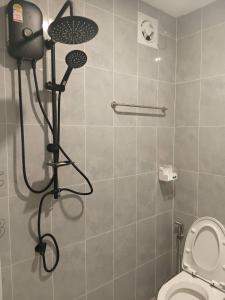 a shower in a bathroom with a toilet at First Light Garden House in Koh Phangan