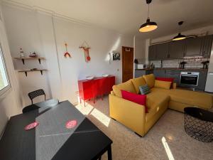 a living room with a yellow couch and a table at MarMontaña in Arinaga +12 photos