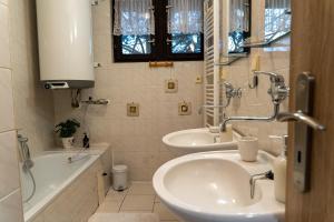 a bathroom with two sinks and a bath tub at Farma Basarovi in Prosečné +81 photos
