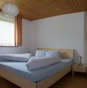 a bedroom with two beds and a window at Chasa Val Bella in Samnaun